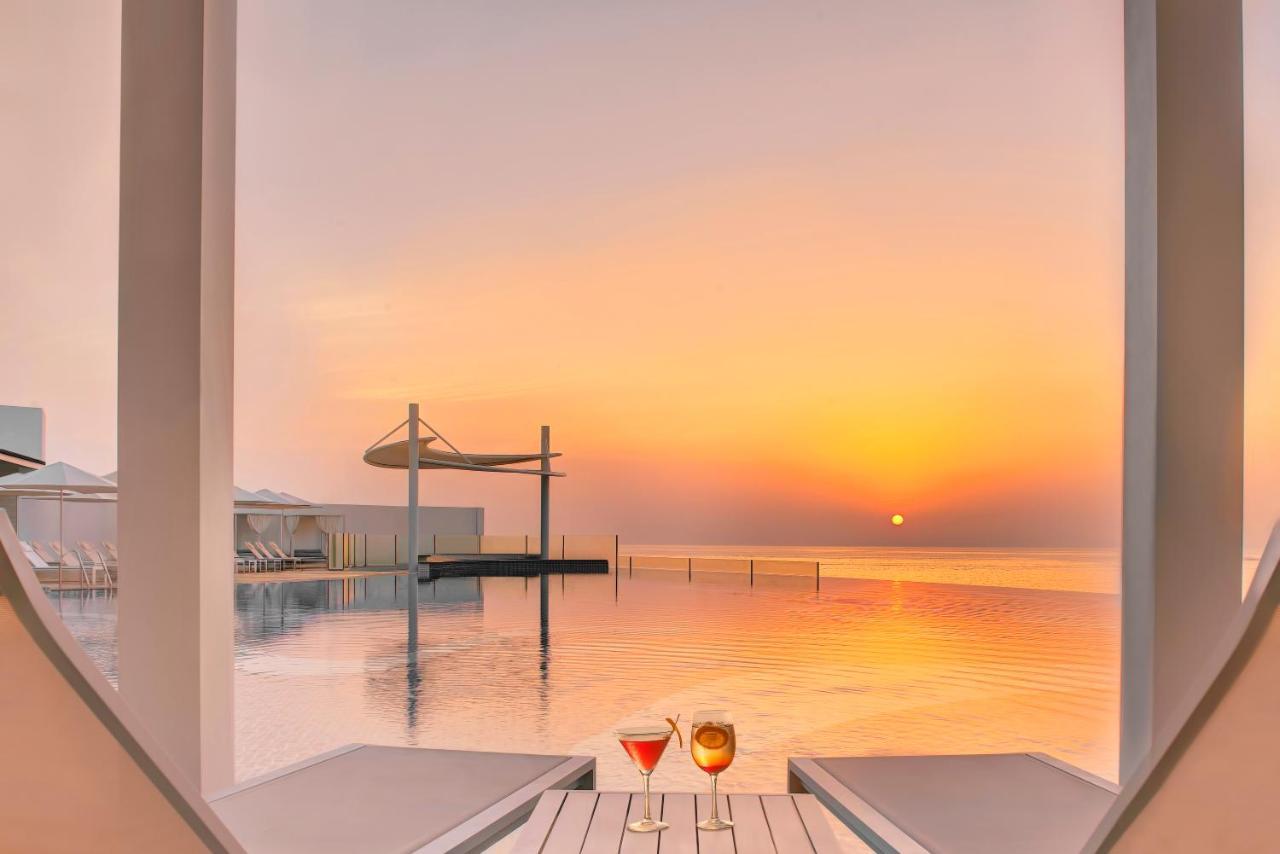 Royal M Al Aqah Beach Resort By Gewan 외부 사진 Sunset at the pool